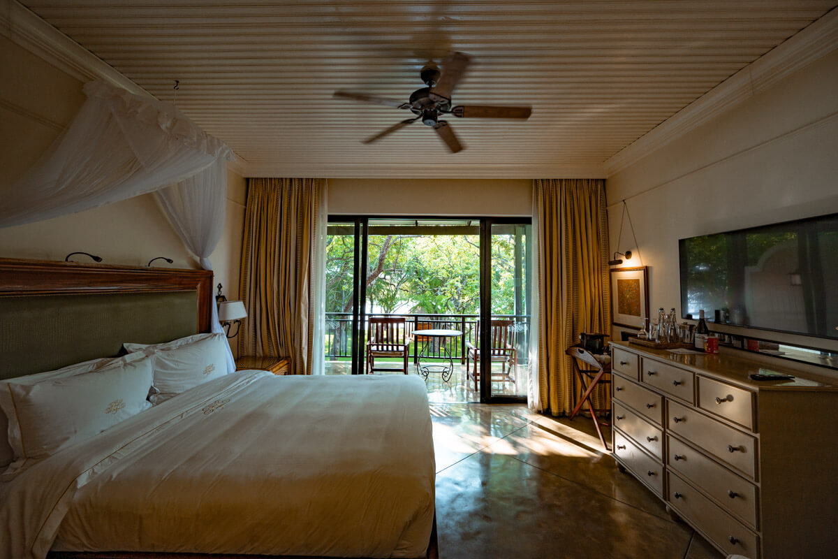 the bedroom of a room at the Royal Livingstone Hotel in Zambia