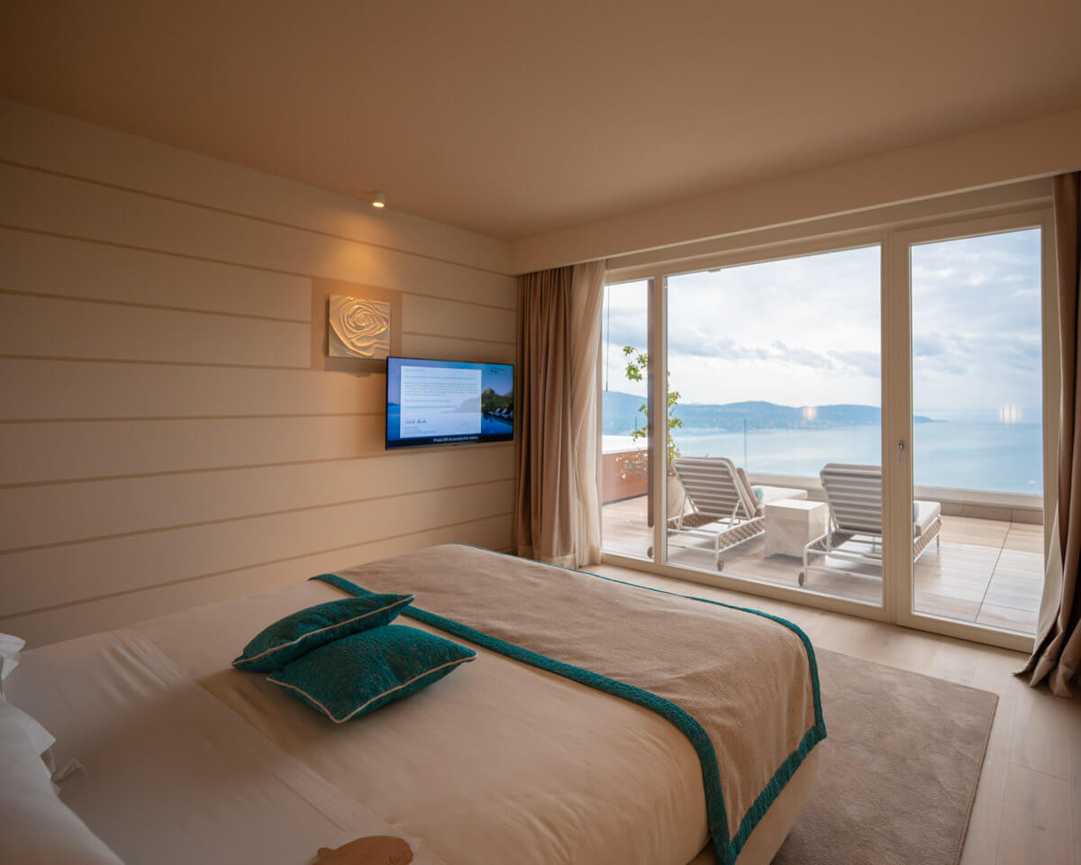 the bedroom of a sky suite at the Lefay Resort & Spa Lago di Garda in Italy with cozy bed and view over the Garda lake