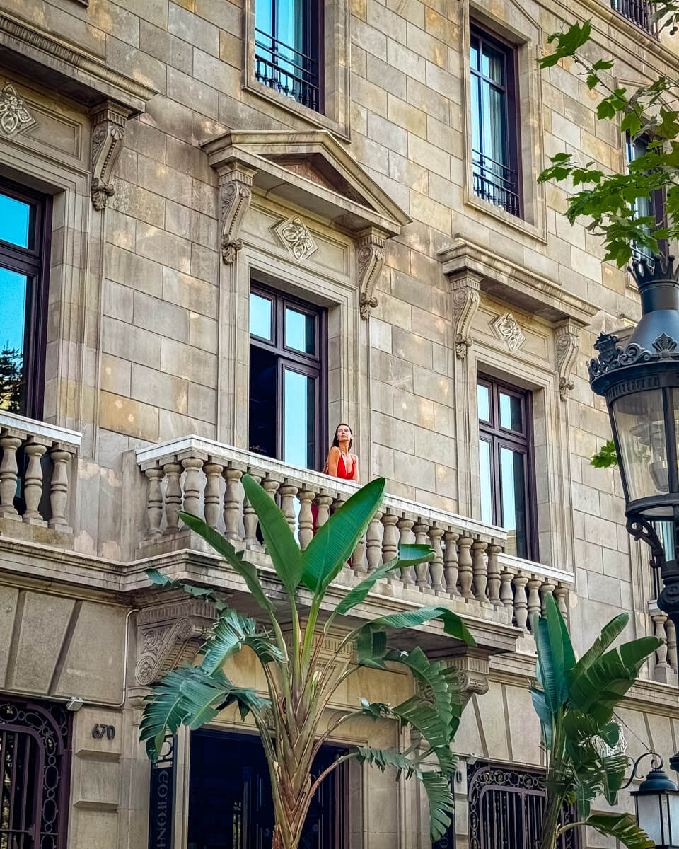 The outside facade of the building of the Cotton House Hotel in Barcelona, standing on balcony