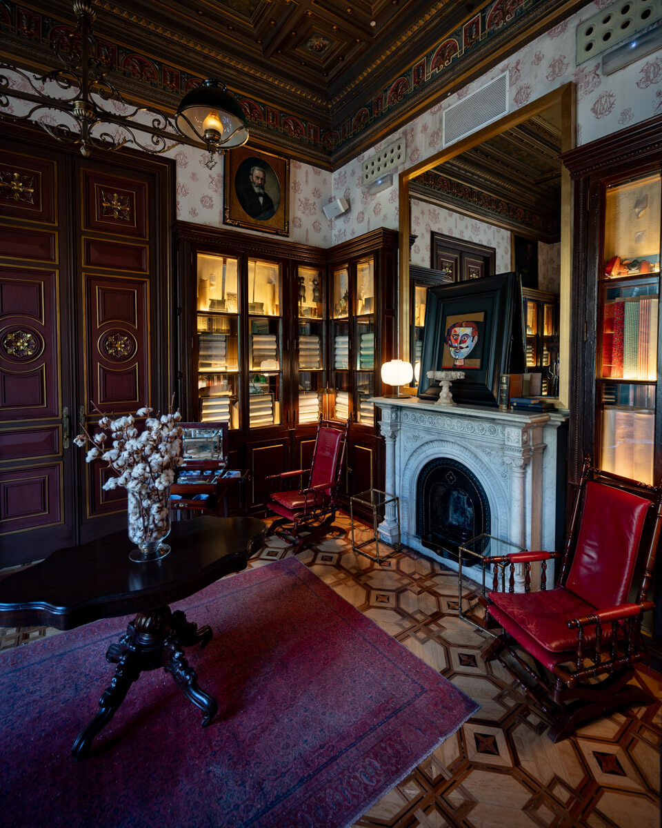 the library at the Cotton House Hotel in Barcelona, with an historic interior and fire place