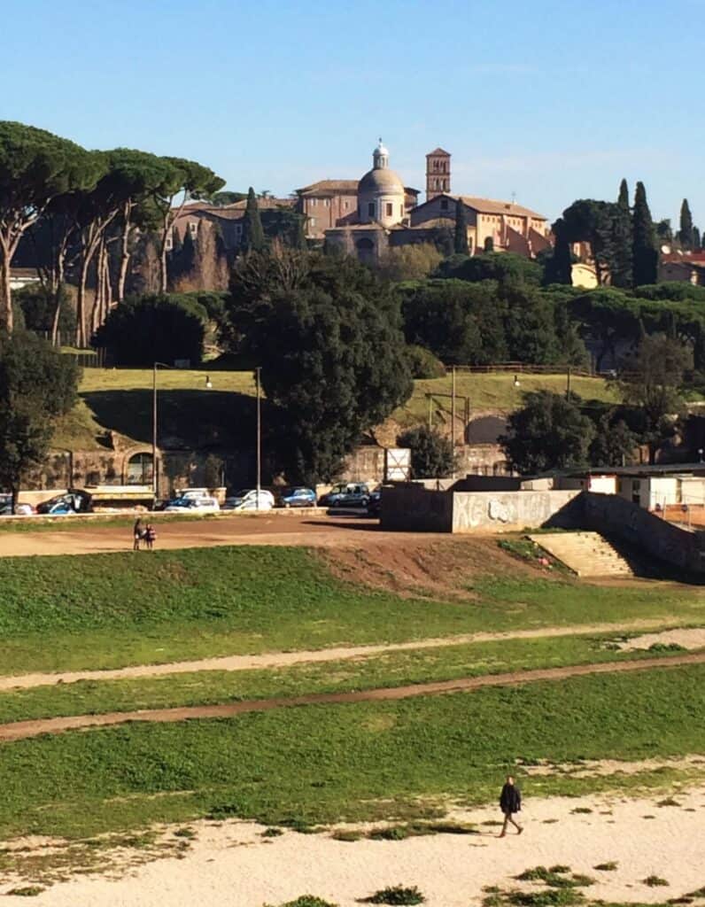 Rome View Of Caelian Hill Church Dome And Bell Tower Seen From Circus Maximus Man Walking