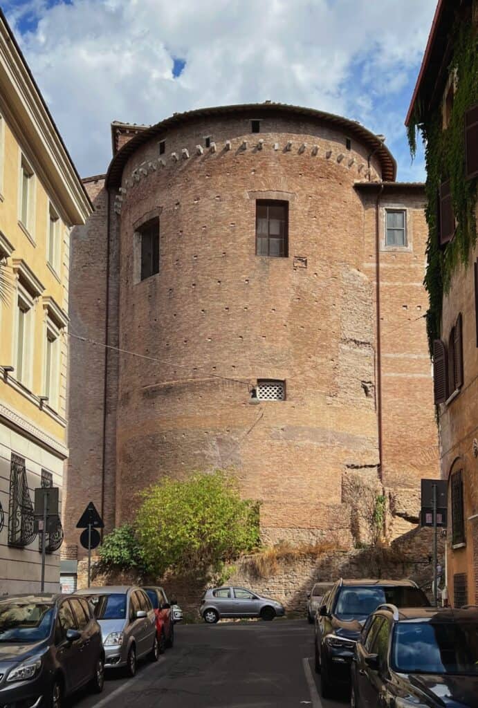 Basilica Dei Santi Quattro Coronati Early Christian Church Exterior Brick Apse View From Street With Parked Cars Celio Rome