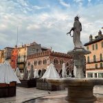Piazza Delle Erbe Medieval Square With Fountain And Madonna Verona Statue Market Umbrellas Morning Light